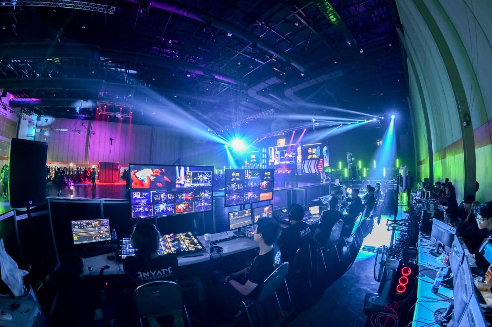 INVATE broadcast control room mid-production, wall of live monitors
