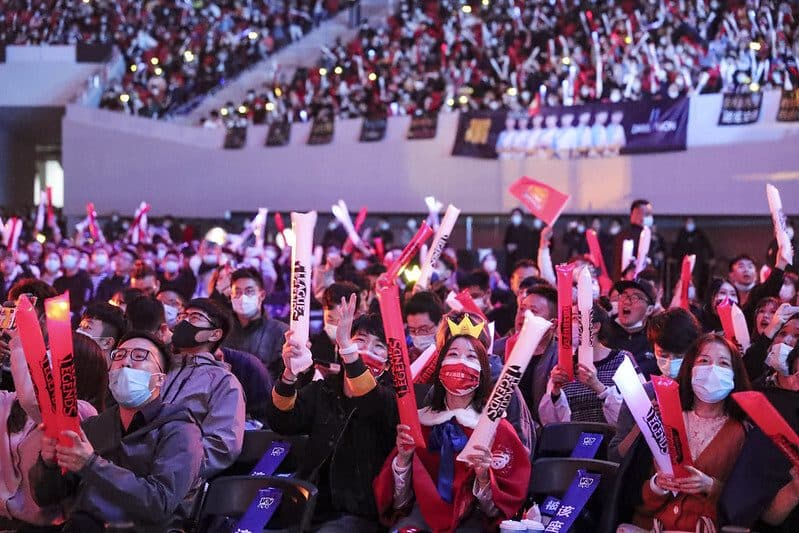 Arena crowd cheering with thundersticks at an INVATE event